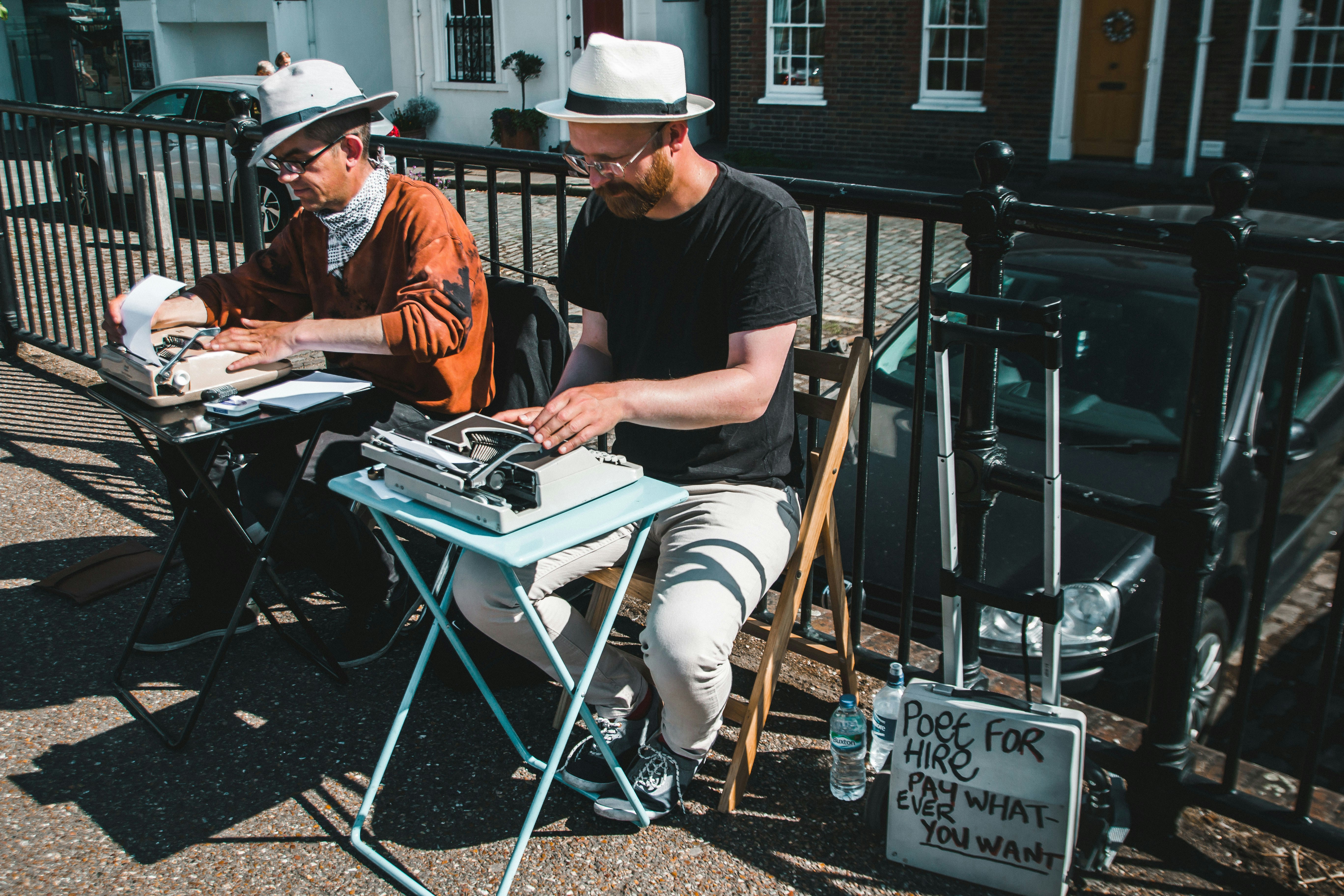 Men typing on typewriters